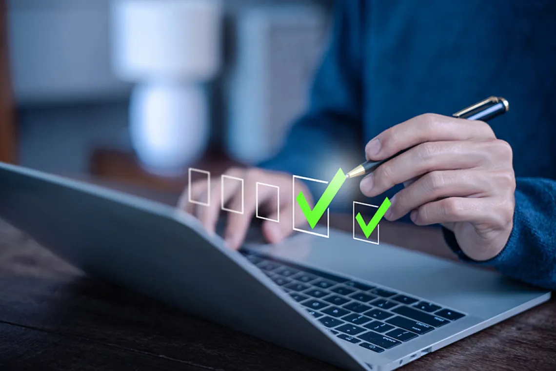 Person checking boxes on laptop.