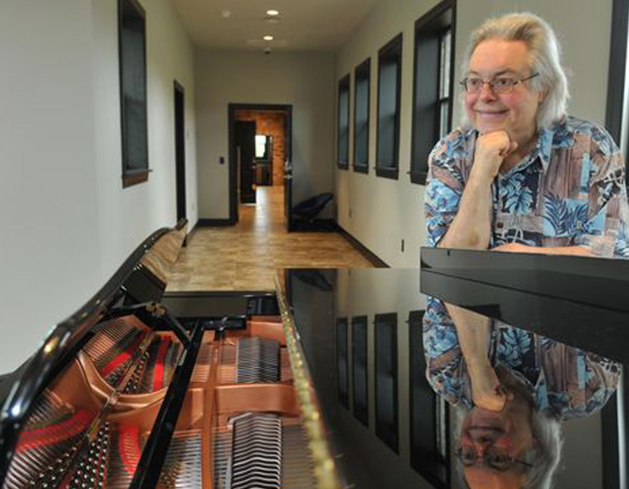 Jose at home with his grand piano