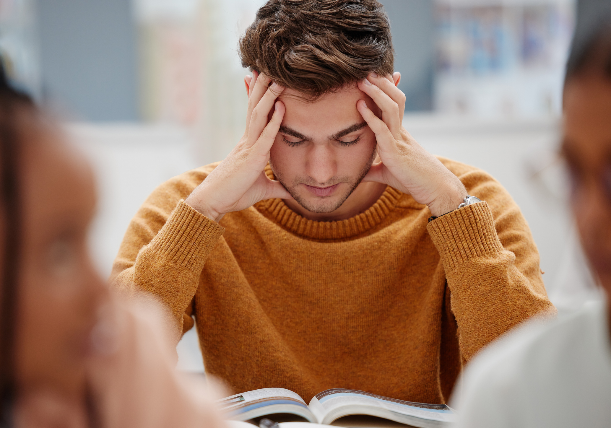 Young man looking at notes, stressed