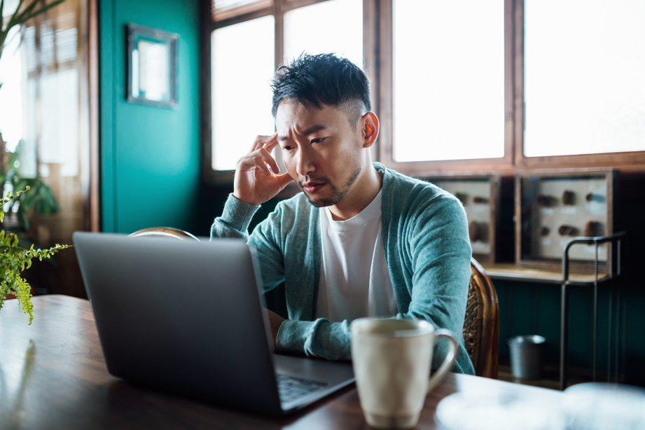 Stressed professional working at computer