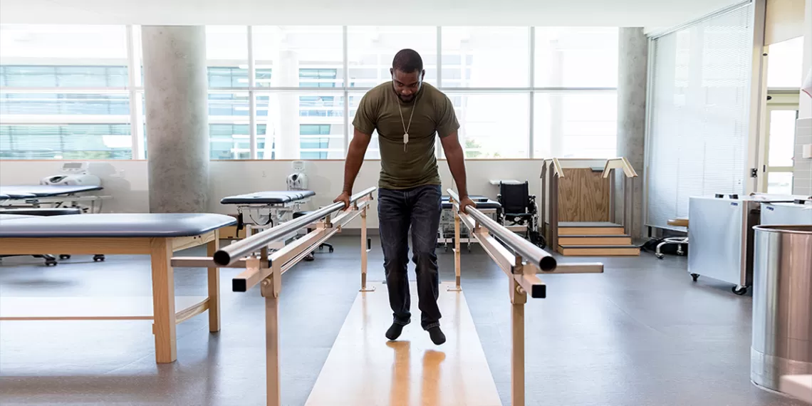 Man practicing physical therapy with bars