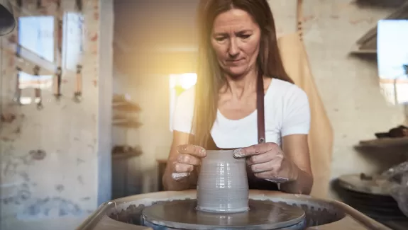 Woman Working at Ceramics and Pottery Wheel