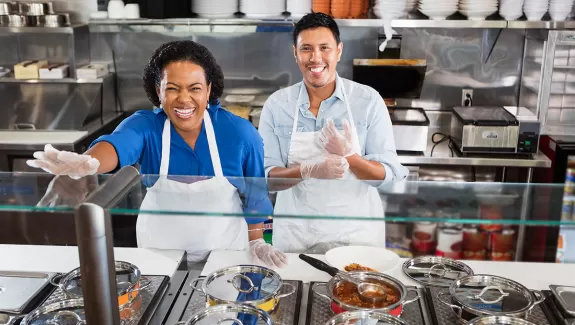 Leadership and Culture OBM series, two smiling people serving food