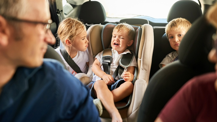 Parents with children misbehaving in the car
