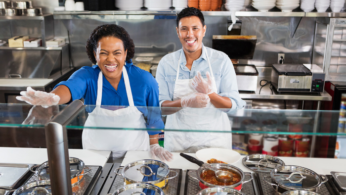 Leadership and Culture OBM series, two smiling people serving food