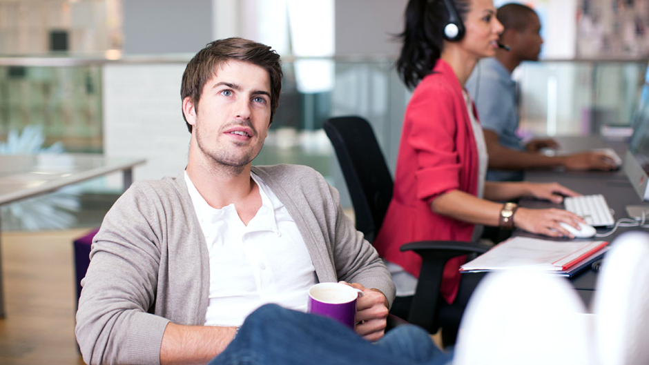 Man in office staring into space