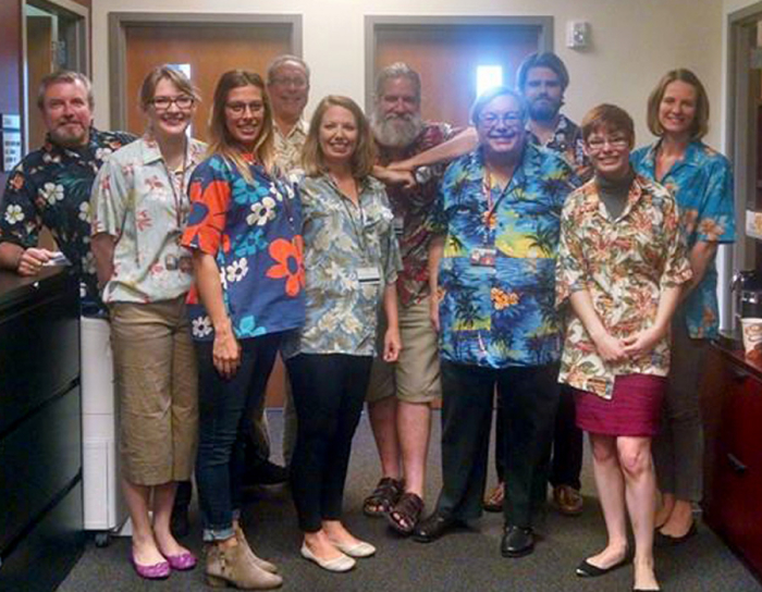 ABA Technologies team in the office wearing hawaiian shirts, Jose's signature style