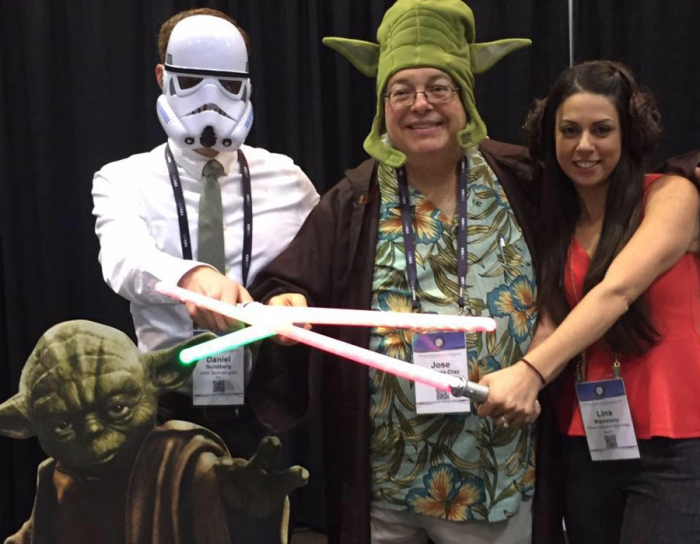 Jose Martinez-Diaz and Lina Majdalany posing with Star Wars props at a conference