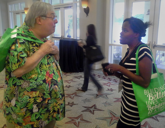 Jose Martinez-Diaz speaking with a student at a conference
